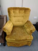 An armchair in mustard buttoned fabric