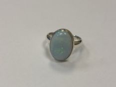 A silver dress ring with opalescent stone,