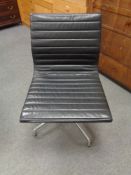 A Vitra Charles Eames designed Alu swivel chair upholstered in black leather with chrome frame