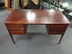 A mid century Danish stained beech writing desk fitted with six drawers