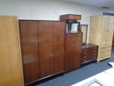 A four piece teak G Plan bedroom suite comprising double door wardrobe, linen chest,