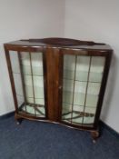 A mid 20th century walnut display cabinet