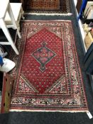 A Persian rug, 159cm by 101cm.