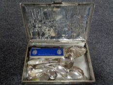 An embossed Macintosh tin containing quantity of plated spoons,