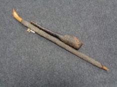 A rustic wooden club and walking stick