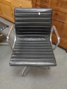 A Vitra Charles Eames designed Alu swivel armchair upholstered in black leather with chrome frame