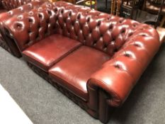 A Chesterfield style red buttoned leather two seater settee