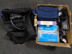 A box of Samsung Sony and Panasonic video cameras with accessories