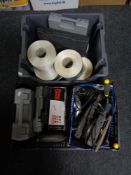 A box of assorted power tools,