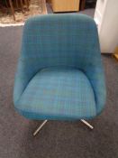 A twentieth century swivel chair upholstered in purple turquoise fabric on chrome swivel base