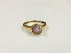 A 9ct gold diamond set amethyst ring, size N.