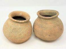 Two ancient terracotta pots, believed to be Thai, height 13 cm.