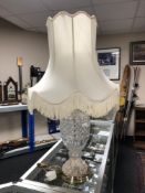 A cut-glass table lamp with shade on brass base