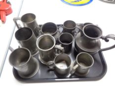 A tray of antique pewter items, tankards,