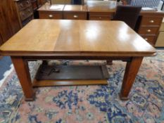 An Edwardian oak dining table