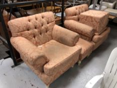 A pair of peach upholstered armchairs and a footstool