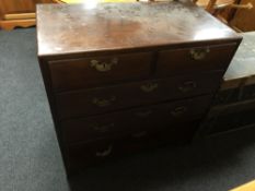 A George III mahogany five drawer chest with brass drop handles on bracket feet