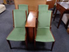 A twentieth century narrow teak drop leaf table together with a set of four teak dining chairs