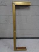 An antique brass fire curb