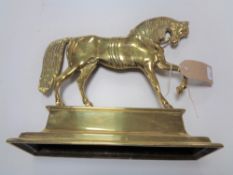 A brass door stop in the form of a horse