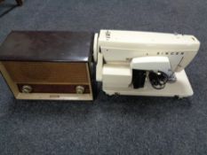 A twentieth century Singer electric sewing machine together with Philips valve radio