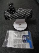 A Celestron 21024 bench top telescope with instructions and interchangeable lens