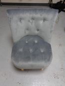 A contemporary buttoned dralon bedroom chair on pine legs