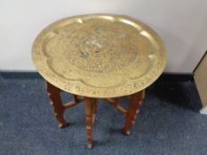 An Eastern brass topped folding table