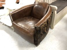 A contemporary brown leather and cow hide armchair
