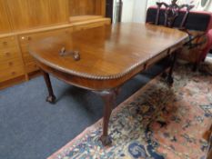 A Victorian mahogany wind out table with leaf and handle on claw & ball feet
