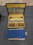 A canteen of stainless steel cutlery together with two further sets of spoons and forks