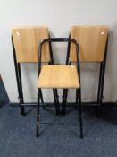 A set of three pine seated metal folding bar stools