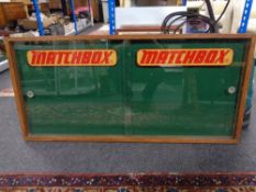 An early twentieth century and later oak framed double door notice board with Matchbox decoration