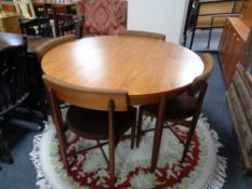 A twentieth century circular teak G-plan Fresco extending dining table and four chairs designed by