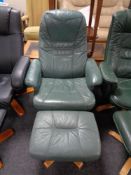 A green leather swivel relaxer chair with stool