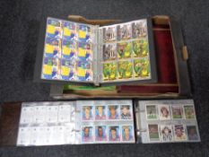 A box of albums containing football stickers,