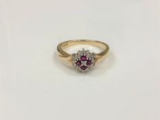 A 9ct gold diamond and ruby cluster ring, size P.