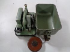 A metal cased surveyor's measure together with a vintage Chesterman leather tape measure