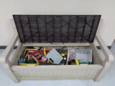 A Keta storage garden bench containing hand tools, power tools,