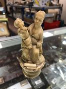 An antique carved ivory figure - Oriental gentleman with child