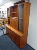 A teak G-plan cocktail display sideboard fitted with drawers