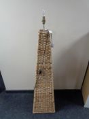 A wicker floor lamp