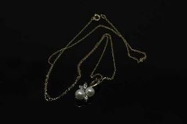A 10ct gold diamond and pearl pendant on yellow gold chain