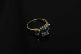 A 10ct gold blue topaz and diamond set ring, size O.