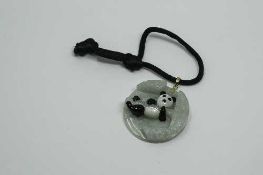 A yellow gold mounted jade 'panda' pendant, diameter 38 mm.