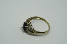 A 10ct yellow gold sapphire and diamond ring, sapphire measures 6 mm x 4 mm, size N.