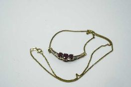 An 18ct yellow gold ruby and diamond pendant on chain,