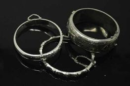 Three silver bangles.