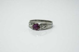 An 18ct white gold ruby and diamond ring, approximately 0.5ct, size K.