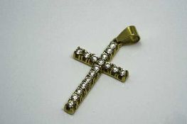 An 18ct yellow gold diamond cross pendant, the seventeen diamonds approximately 0.6ct.